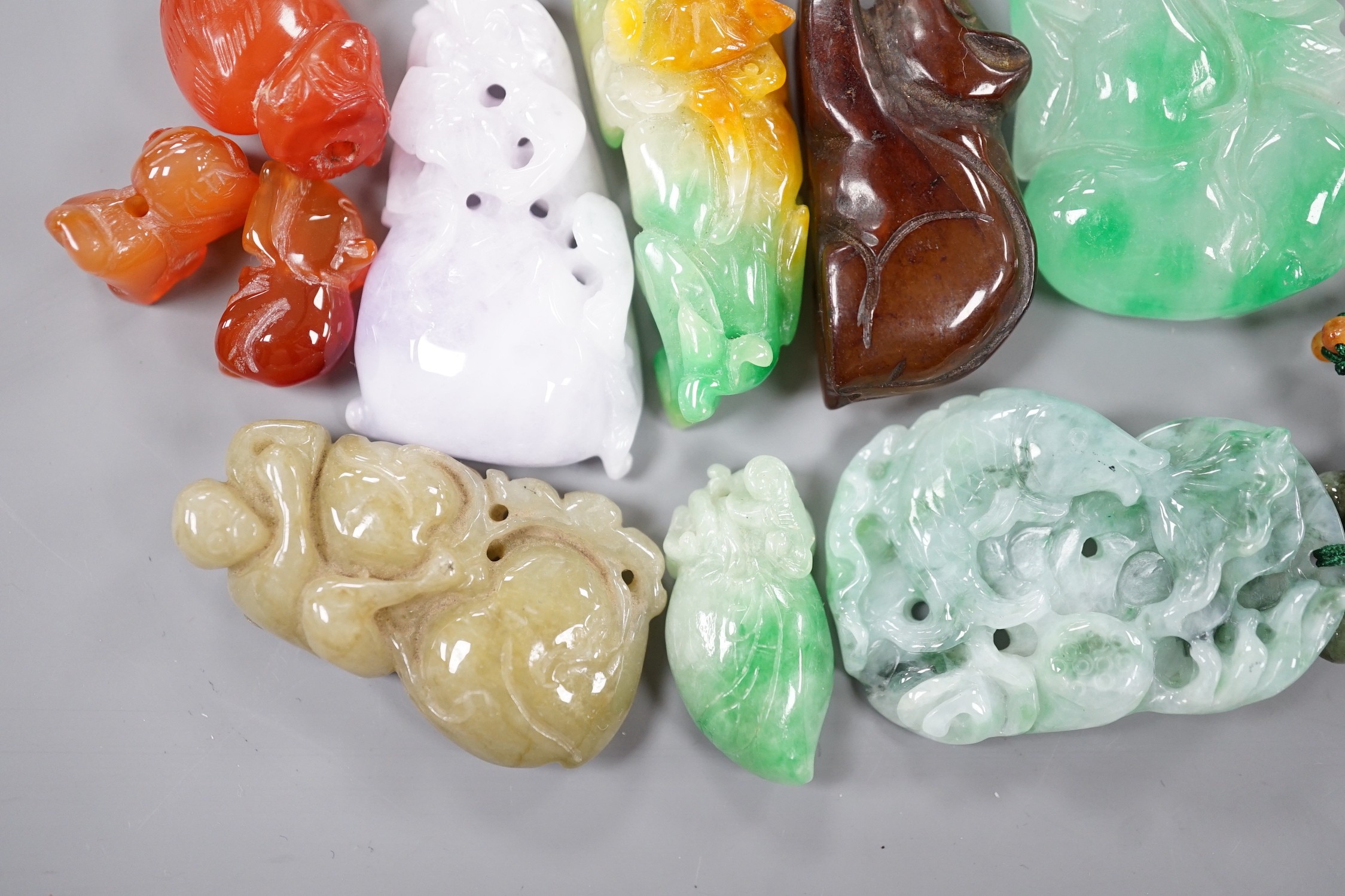 A group of ten jadeite and hardstone carvings and pendants